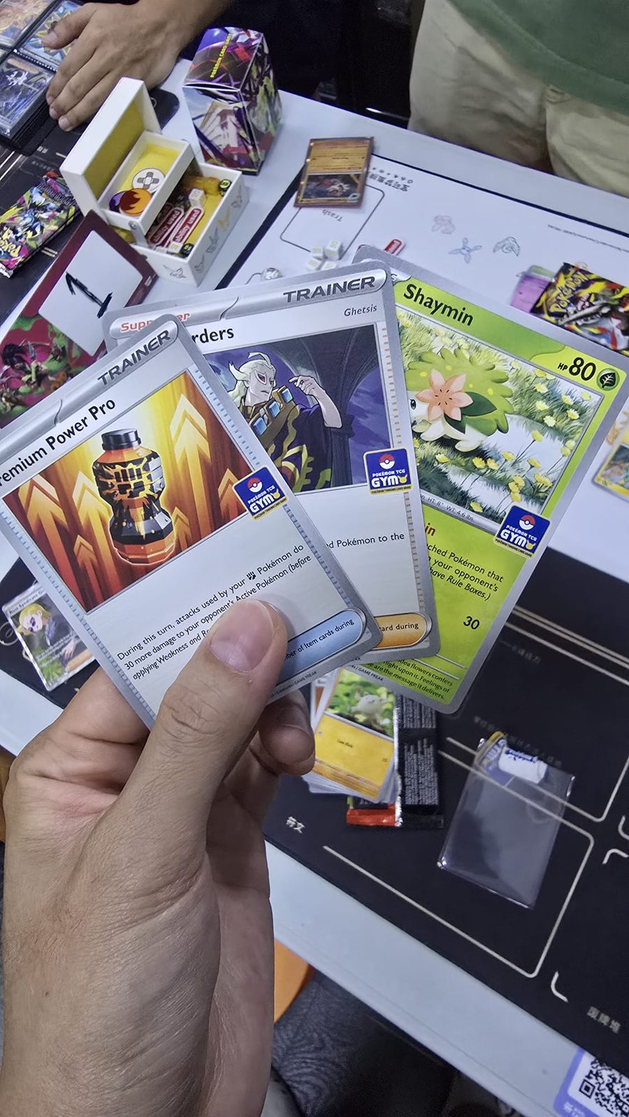 Trainer and Supporter cards fanned out at a Pokémon TCG Gym event
