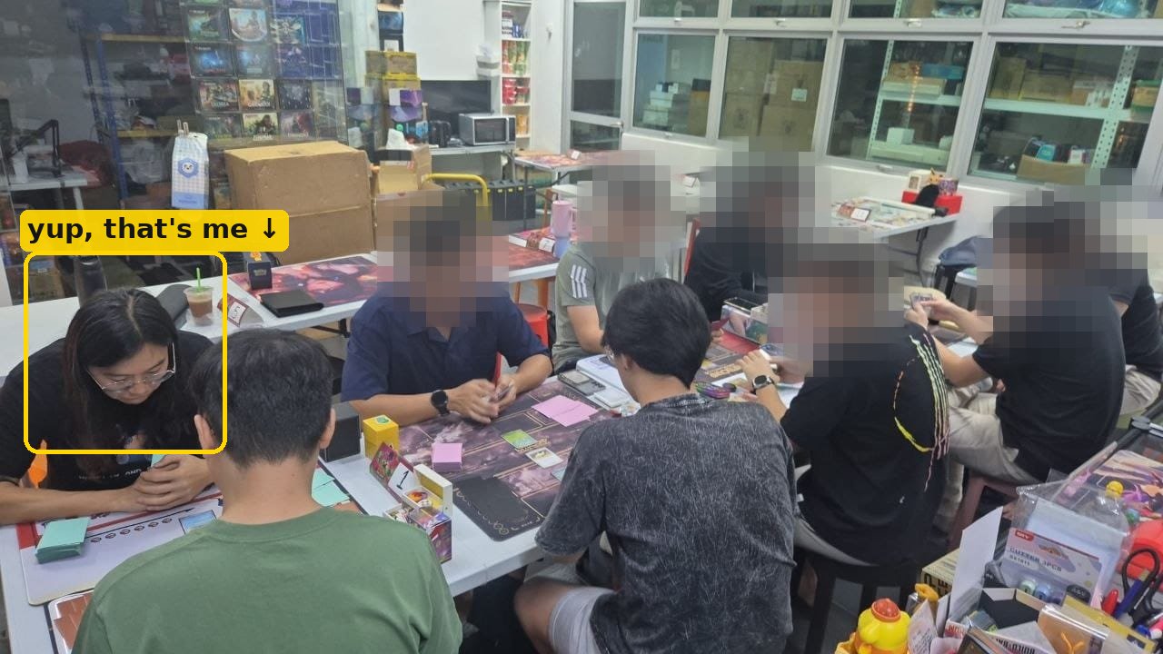 Jack (highlighted) playing in a group TCG session at a BlackLabel gym event, other players' faces blurred for privacy