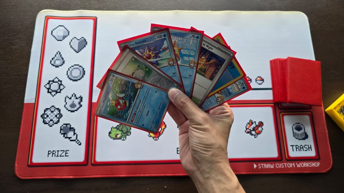 A hand of seven Pokémon cards fanned out over the playmat